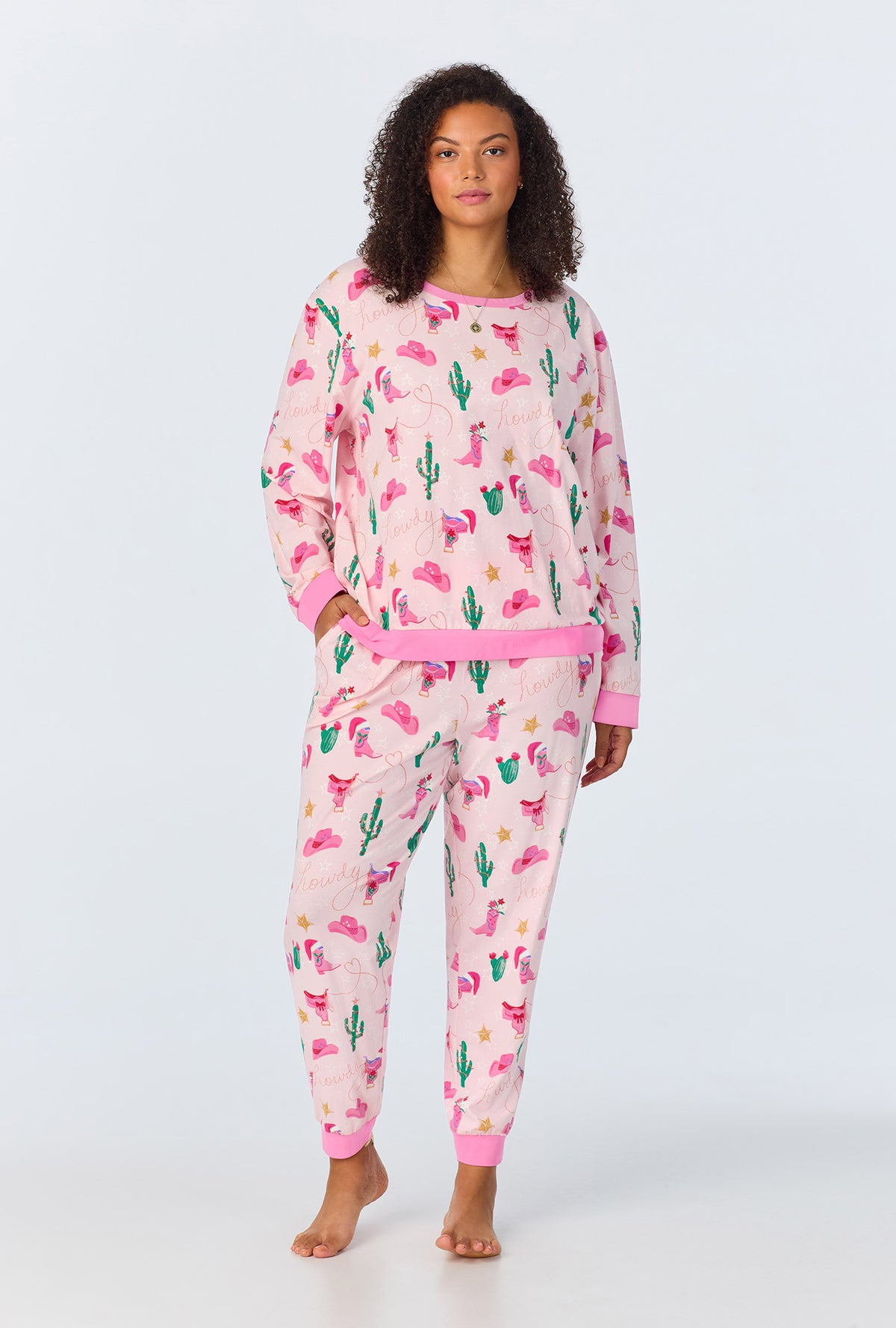 A lady wearing Christmas Cowgirl Long Sleeve Pullover Crew and Jogger Stretch Jersey PJ Set
