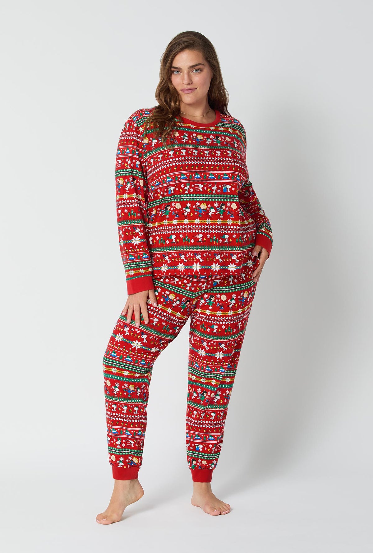 A lady wearing Peanuts®  Winter Fairisle Long Sleeve Pullover Crew And Jogger Stretch Jersey Pj Set