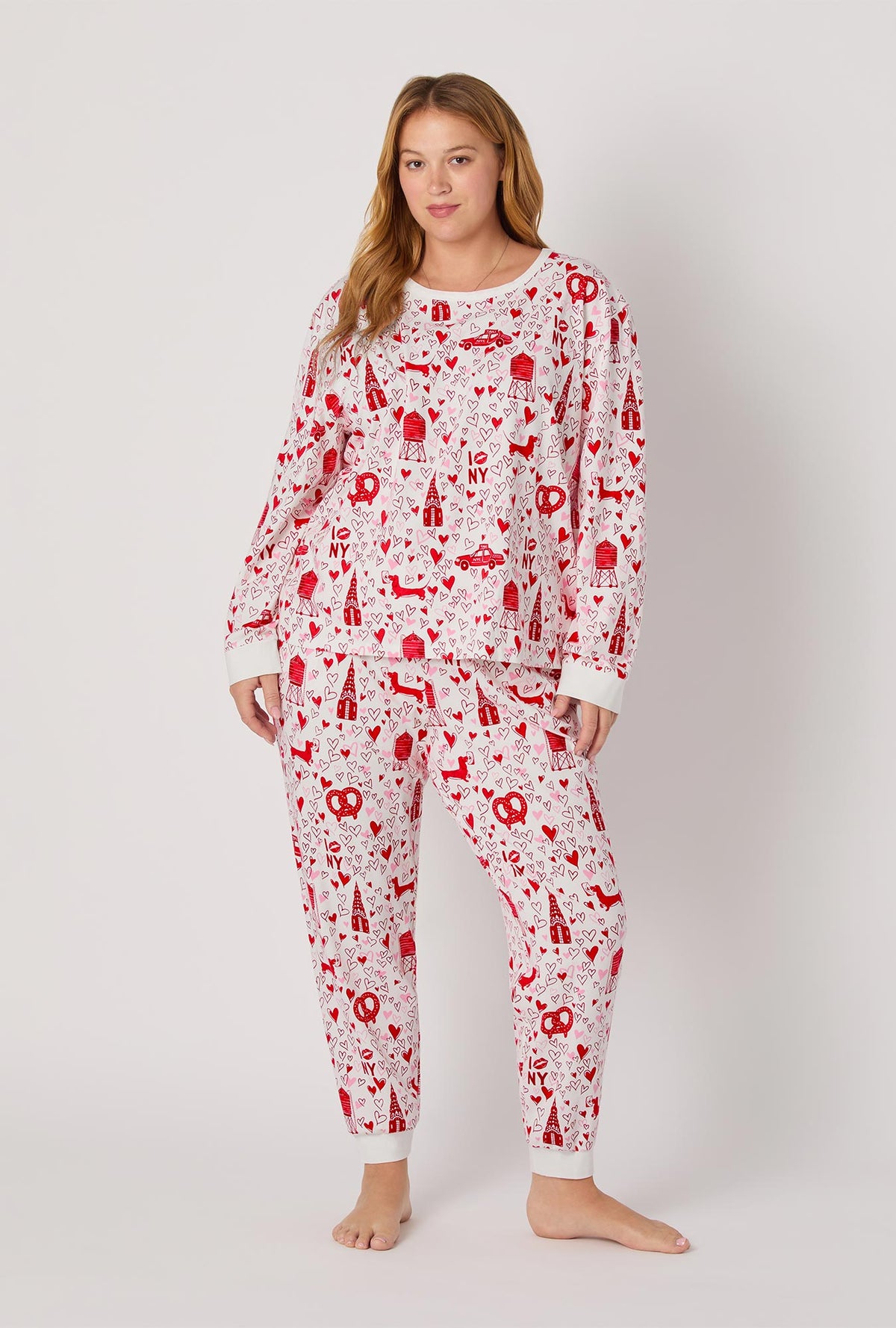A lady wearing Heart Of The City Long Sleeve Pullover Crew And Jogger Stretch Jersey Pj Set