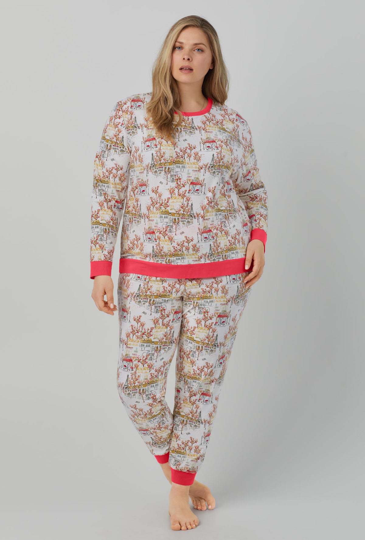 A lady wearing Long Sleeve Pullover Crew and Jogger Stretch Jersey PJ Set with fall in paris print.
