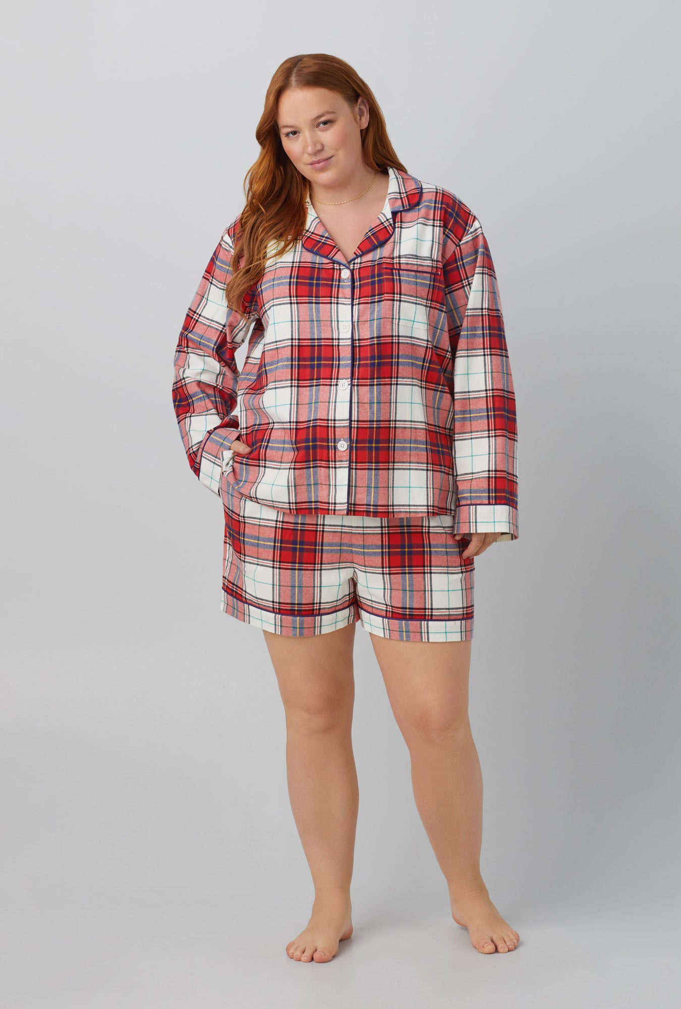 A lady wearing red Long Sleeve Classic Shorty Woven Cotton Portuguese Flannel PJ Set with Festive Tartan print