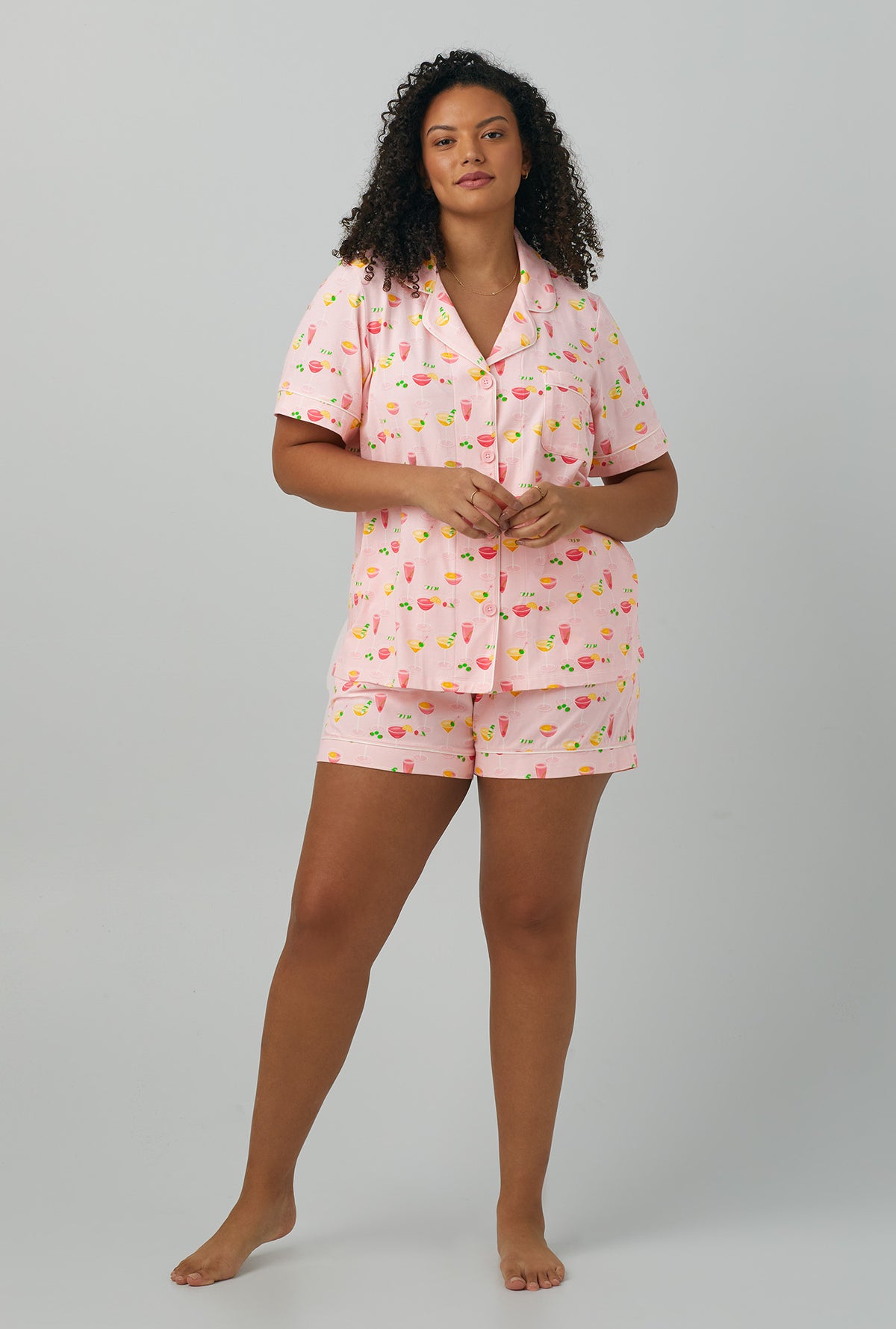 A lady wearing plus size  pink Short Sleeve Classic Shorty Stretch Jersey PJ Set with Pink Mixology print