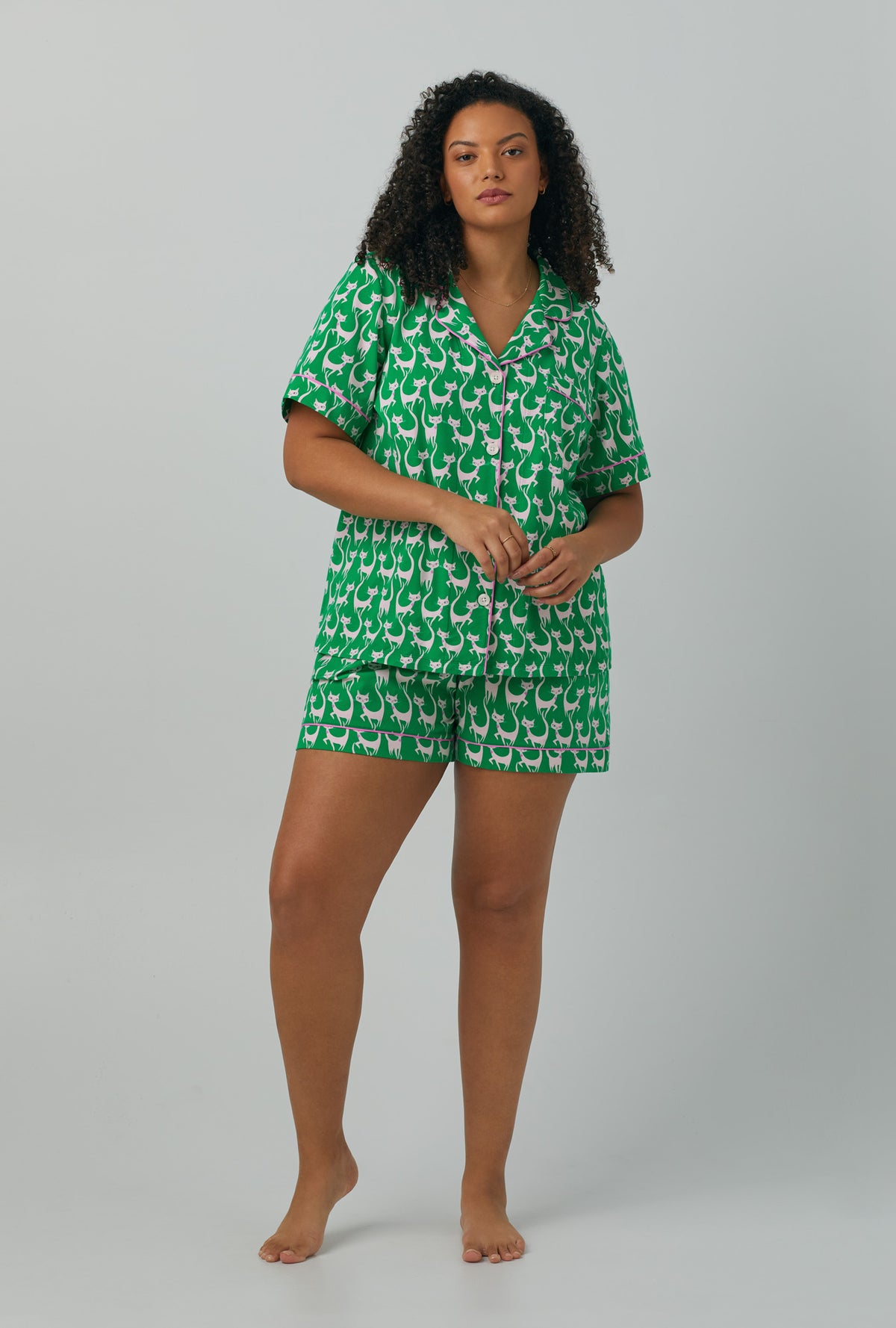 A lady wearing plus size green Short Sleeve Classic Shorty Stretch Jersey PJ Set with Cool Cats print