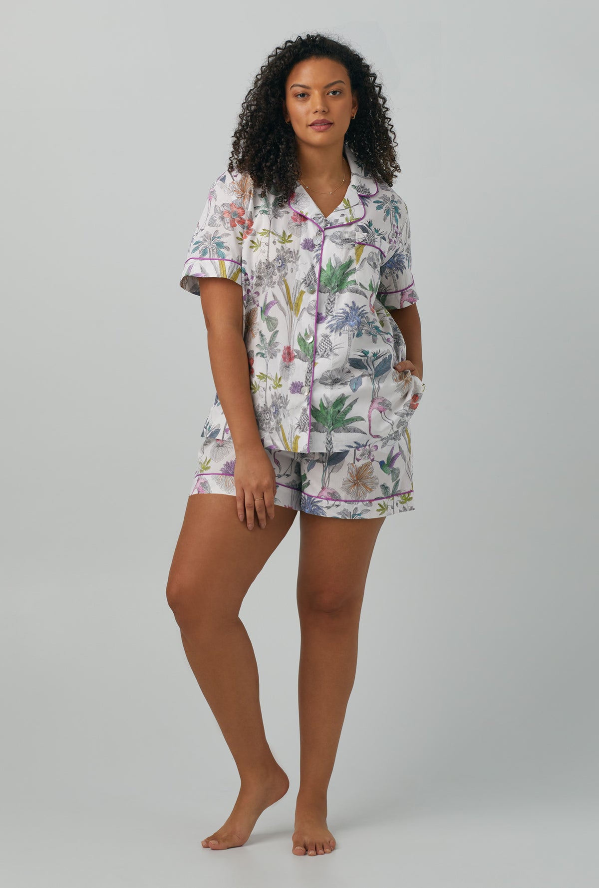 A lady wearing plus size multi color Short Sleeve Classic Woven Cotton Shorty PJ Set with Darwin&#39;s Journey print