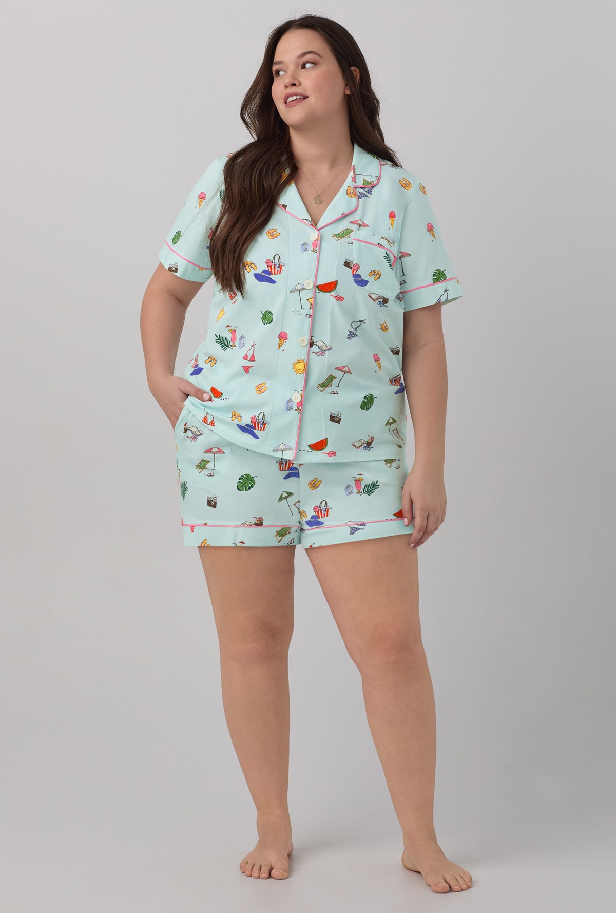 A lady wearing blue short sleeve classic shorty stretch jersey plus size pj set with beach day print