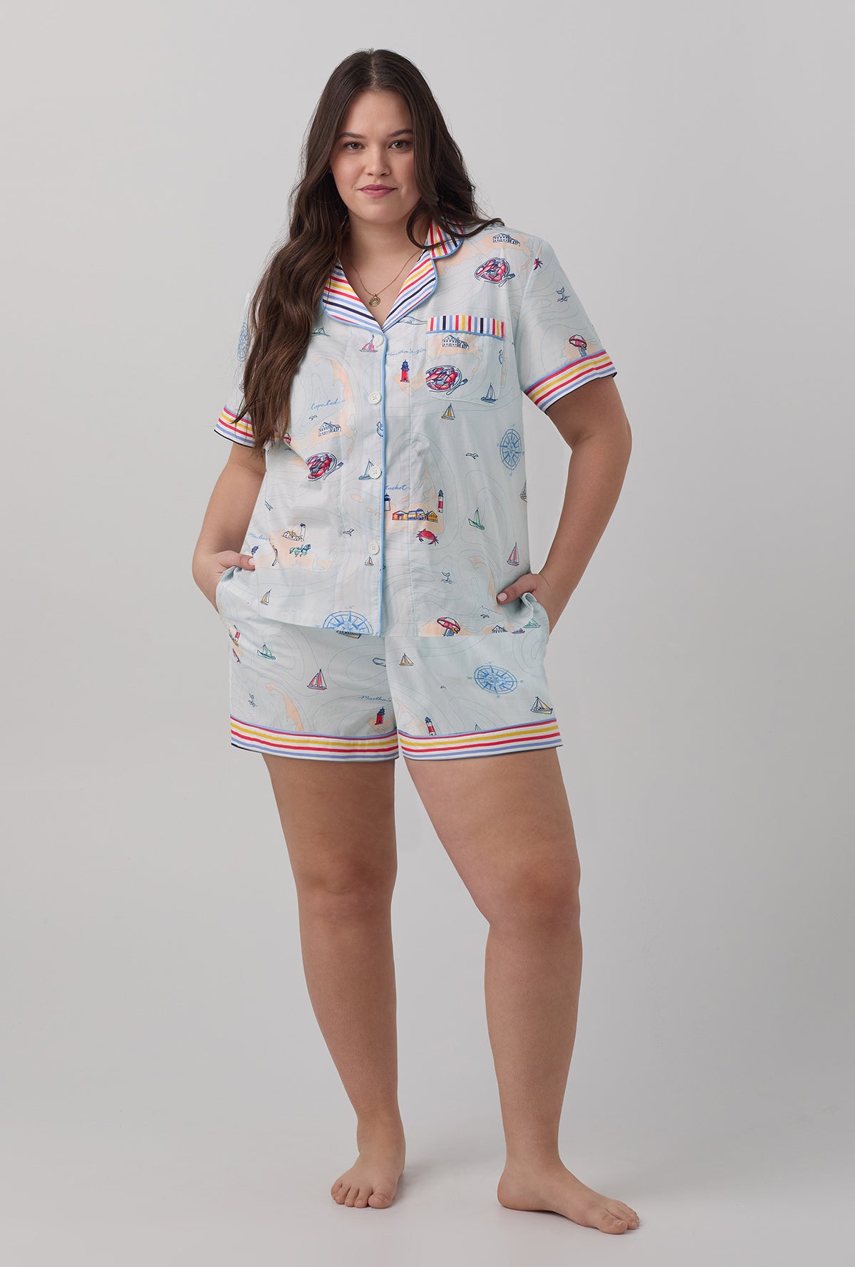 A lady wearing multi color short sleeve classic shorty woven cotton poplin  plus size pj set with eastern seaboard print.