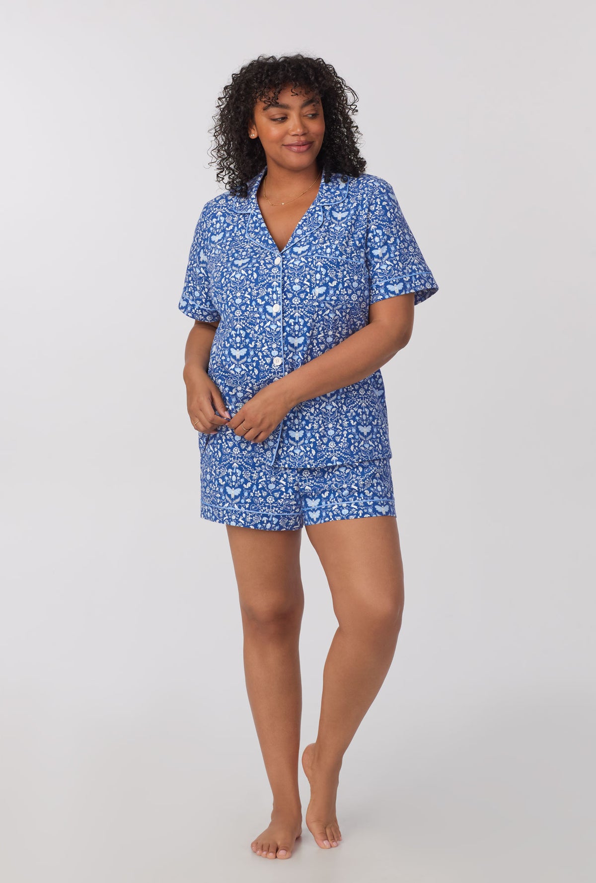 A lady wearing plus size Short Sleeve Classic Shorty Stretch Jersey PJ Set with Through The Woods print 