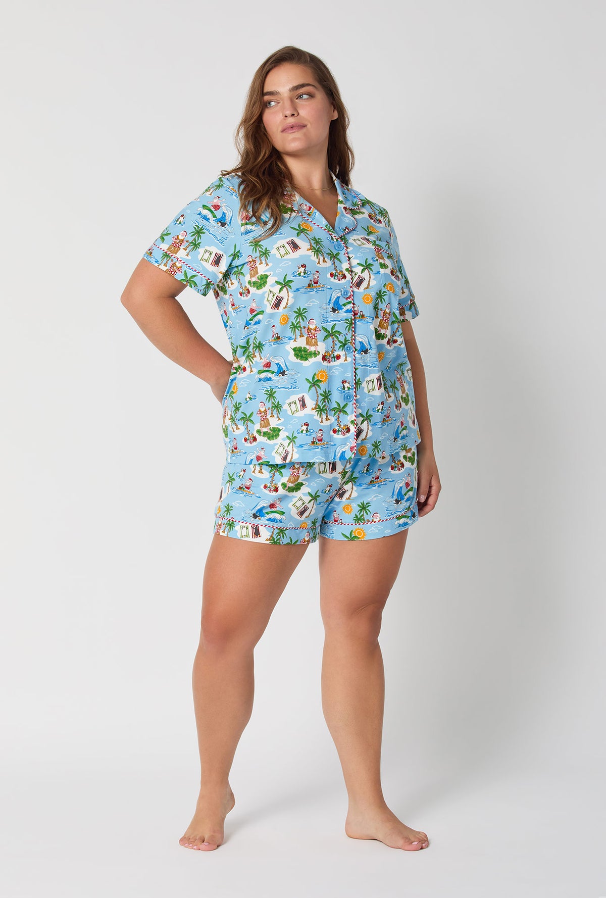 A lady wearing Surfin&#39; Santa Short Sleeve Classic Shorty Stretch Jersey Pj Set