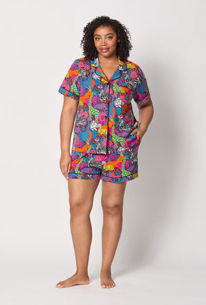 A lady wearing plus size BedHead x Trina Turk Jungle Short Sleeve Classic Shorty Stretch Jersey Pj Set
