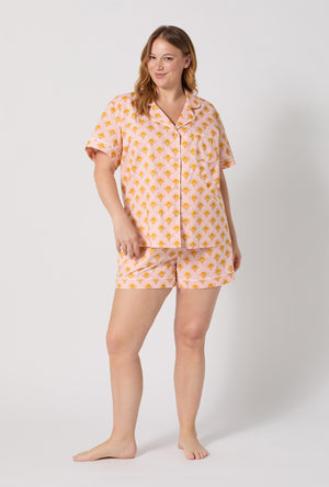 A Lady Wearing Plus Size Deco Sunset Short Sleeve Classic Woven Cotton Poplin Shorty Pj Set posing with a front view look