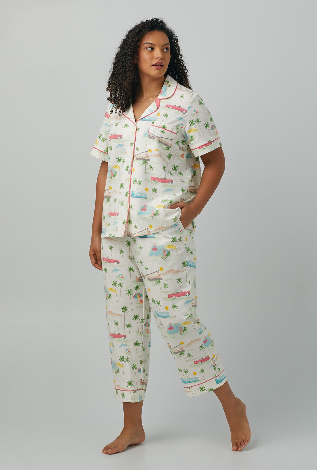 A lady wearing plus size white Short Sleeve Classic Stretch Jersey Cropped PJ Set with Welcome to Palm Springs print