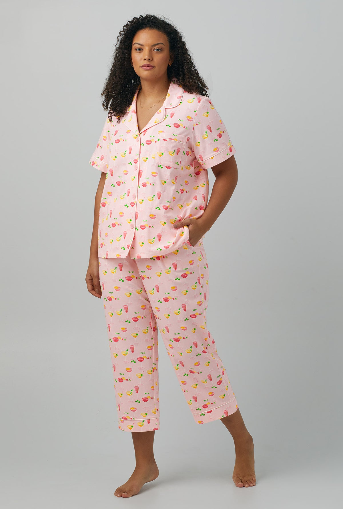 A lady wearing plus size pink  Short Sleeve Classic Stretch Jersey Cropped PJ Set with Pink Mixology print