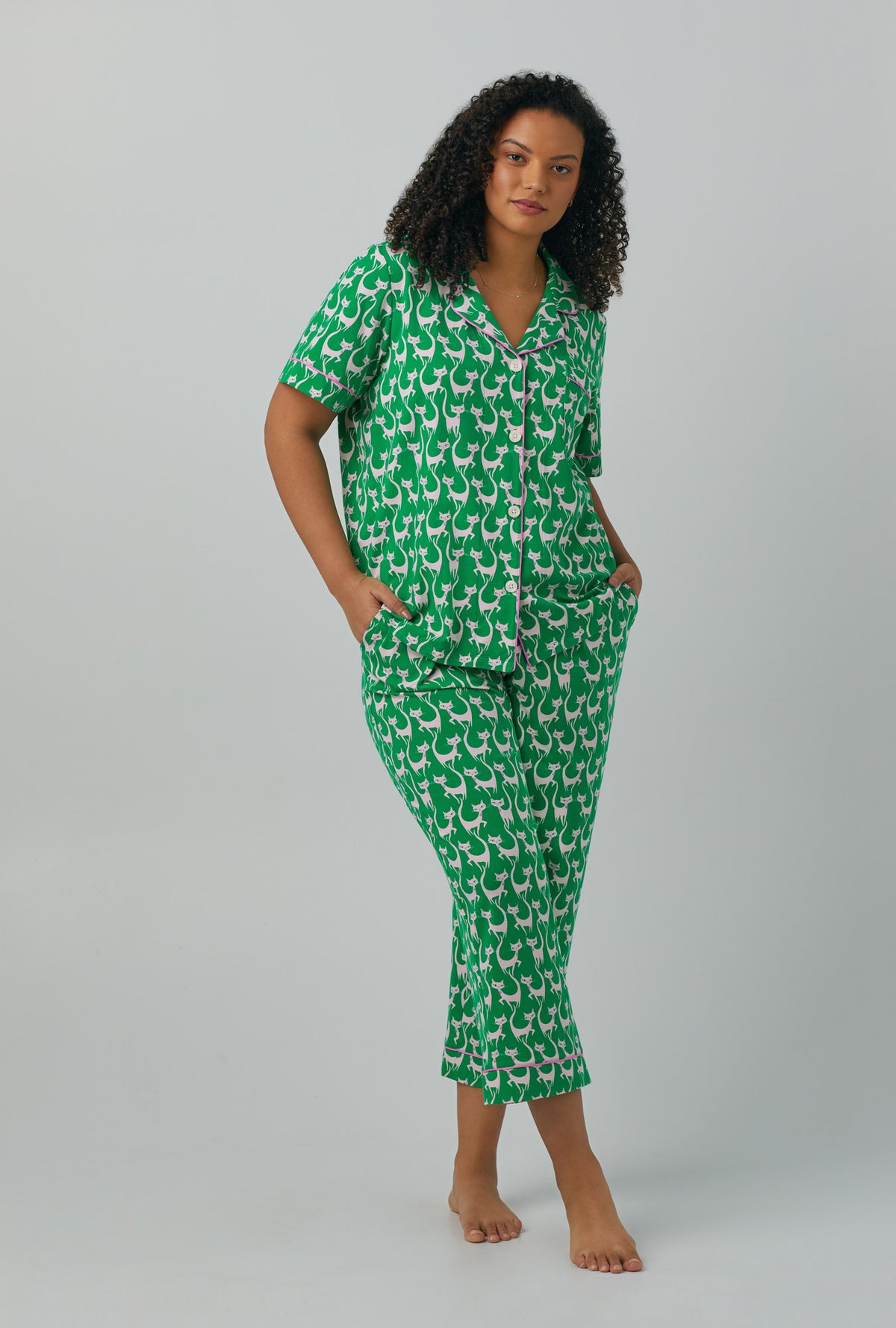 A lady wearing green plus size Short Sleeve Classic Stretch Jersey Cropped with Cool Cats  print