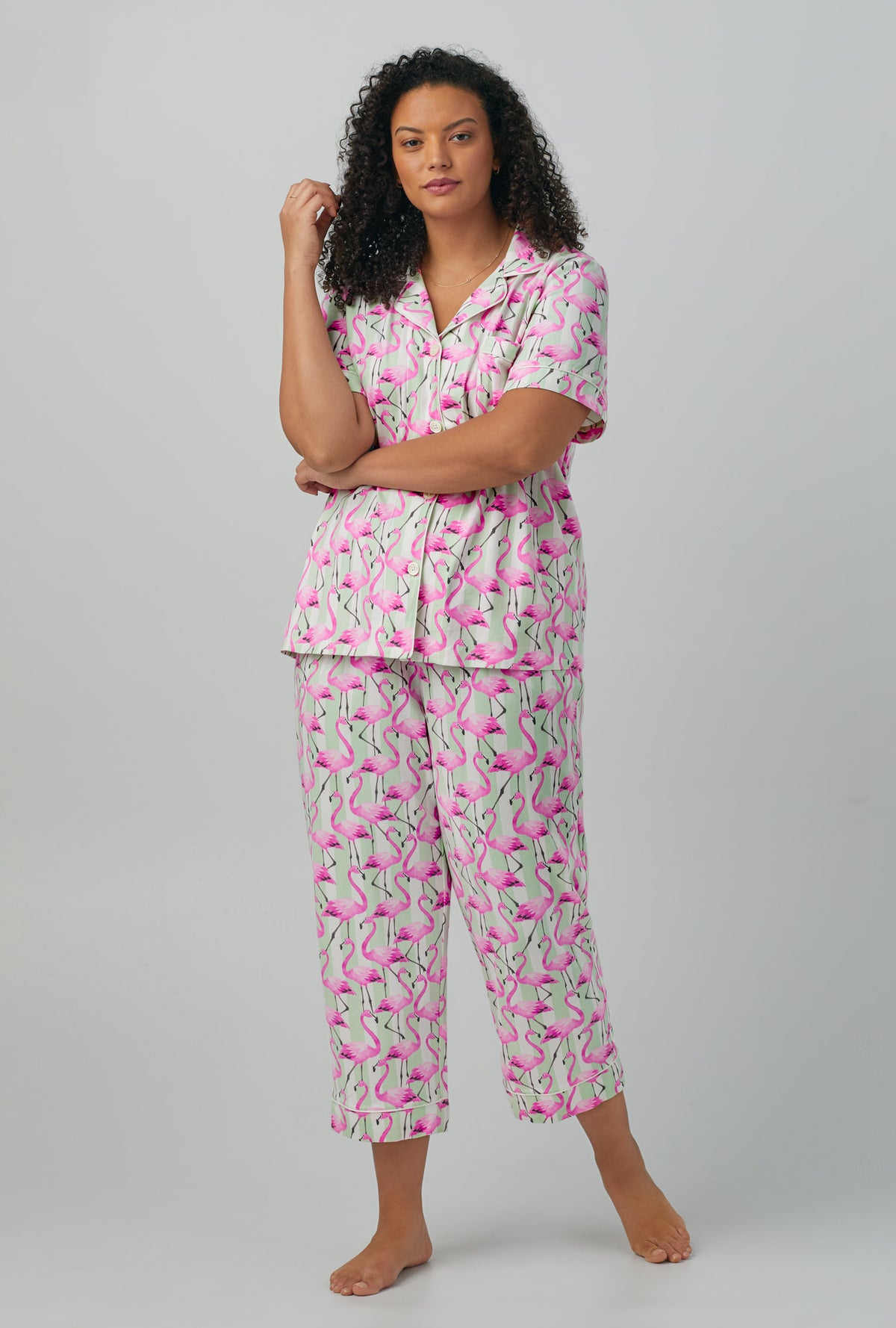 A lady wearing plus size pink Short Sleeve Classic Stretch Jersey Cropped PJ Set with Flamingo Bay print
