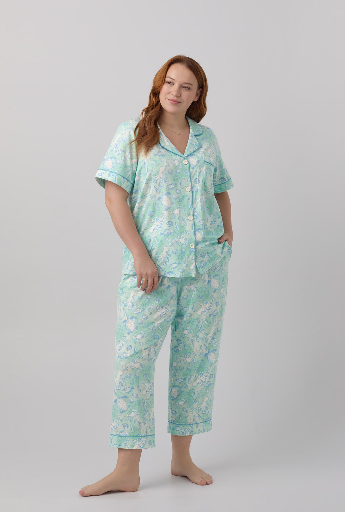 A lady wearing short sleeve stretch jersey cropped plus size pj set with aquatic life print