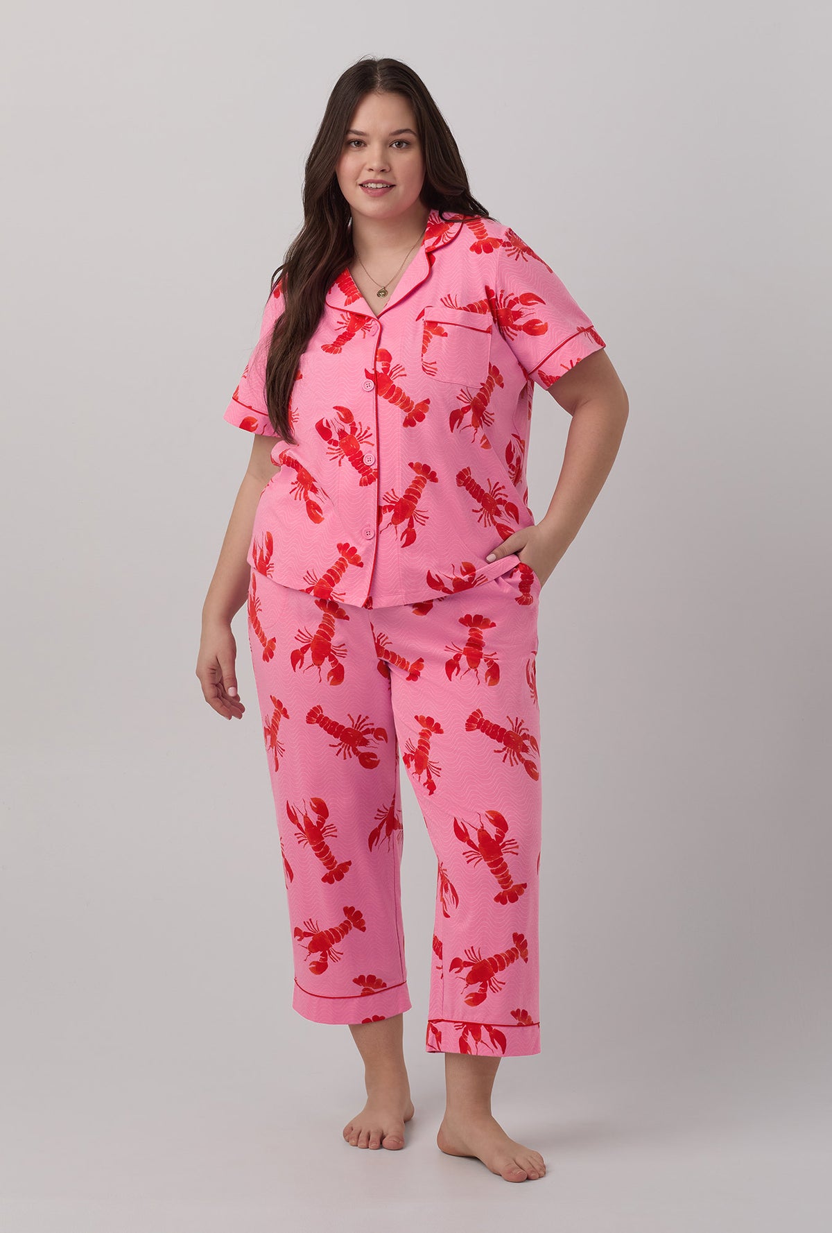 A lady wearing plus size  pink  Short Sleeve Classic Stretch Jersey Cropped PJ Set with Lobster Fest print.