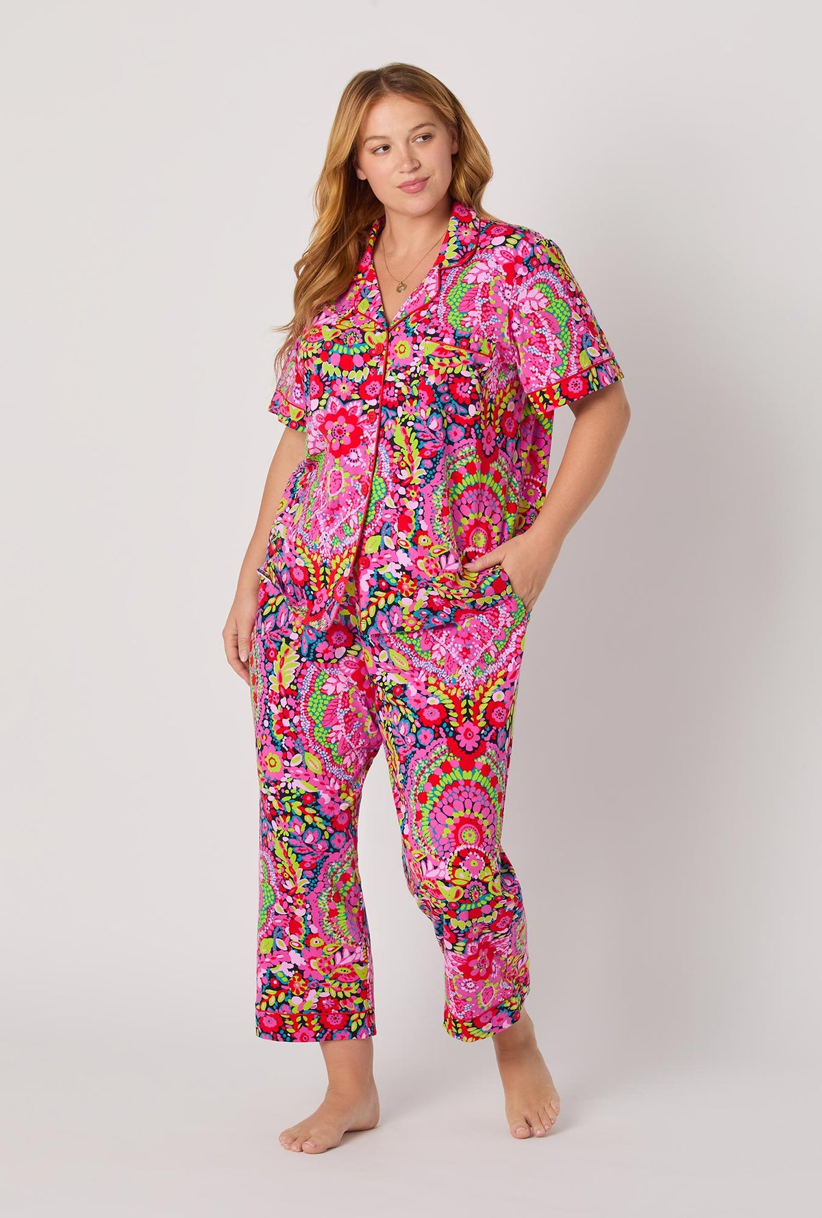 A lady wearing BedHead x Trina Turk Las Flores Short Sleeve Classic Stretch Jersey Cropped Pj Set