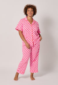 A lady wearing plus size BedHead x Trina Turk Scallop Short Sleeve Classic Stretch Jersey Cropped Pj Set
