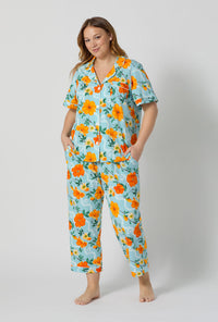 A lady wearing plus size Golden Breeze Short Sleeve Classic Stretch Jersey Cropped Pj Set 