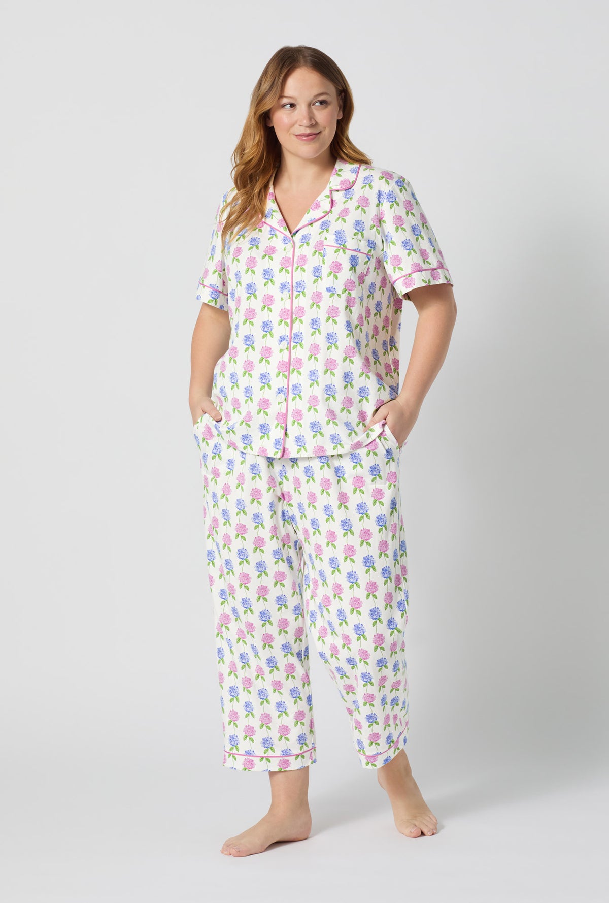 A lady wearing plus size Cottage Parlor Short Sleeve Classic Stretch Jersey Cropped Pj Set