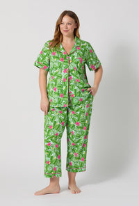 A Lady Wearing Plus Size Monstera Bloom Short Sleeve Classic Stretch Jersey Cropped Pj Set posing with a front view