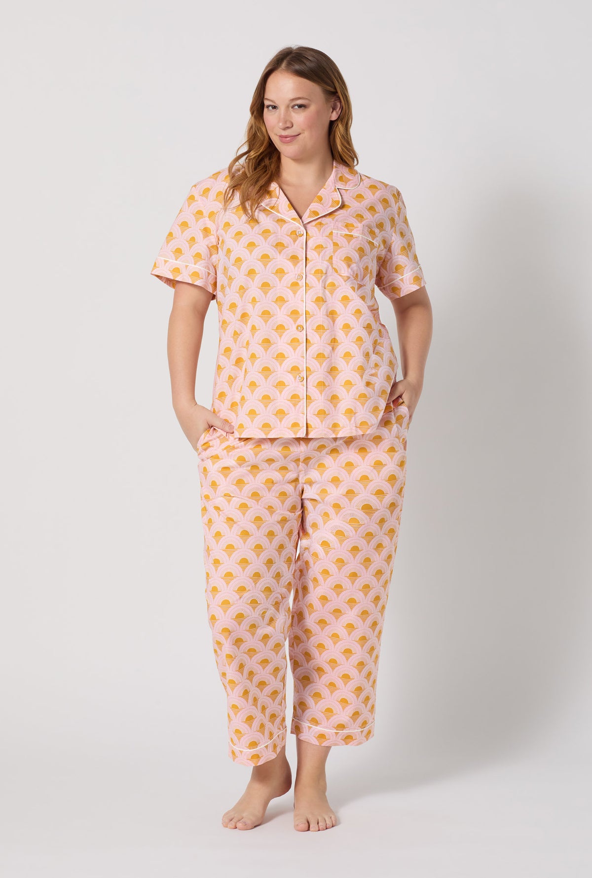 A Lady Wearing Plus Size Deco Sunset Short Sleeve Classic Woven Cotton Poplin Cropped Pj Set posing with a front view