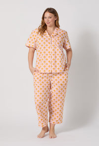 A Lady Wearing Plus Size Deco Sunset Short Sleeve Classic Woven Cotton Poplin Cropped Pj Set posing with a front view