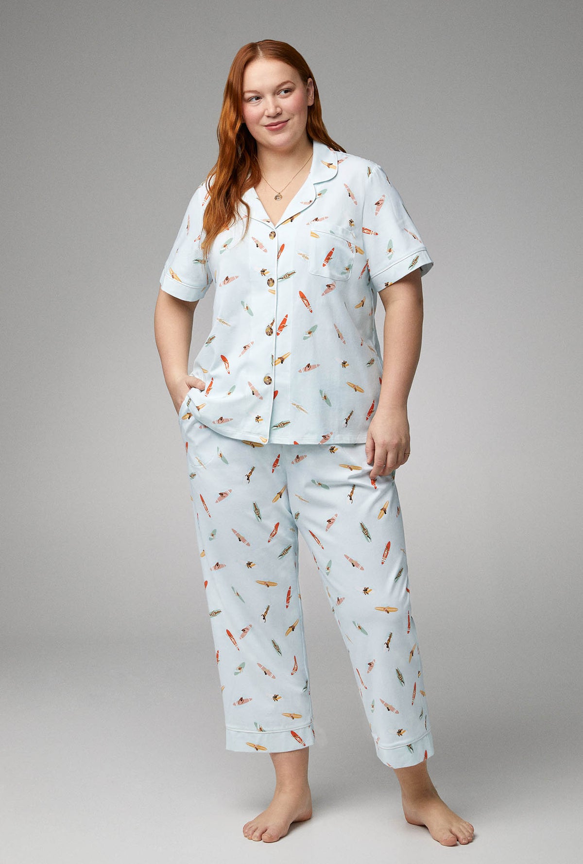 A lady wearing white short sleeve classic stretch jersey plus size pj set with retro surf print.