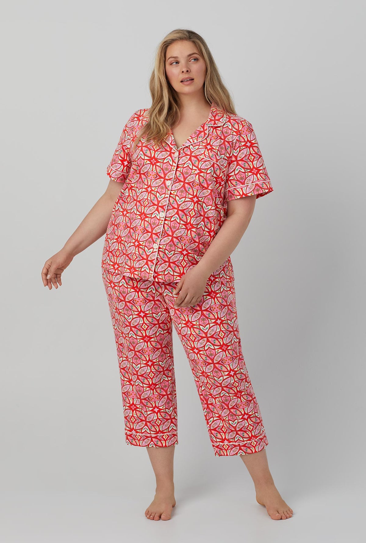 A lady wearing red Short Sleeve Classic Stretch Jersey Cropped PJ Set with Prairie Dawn print