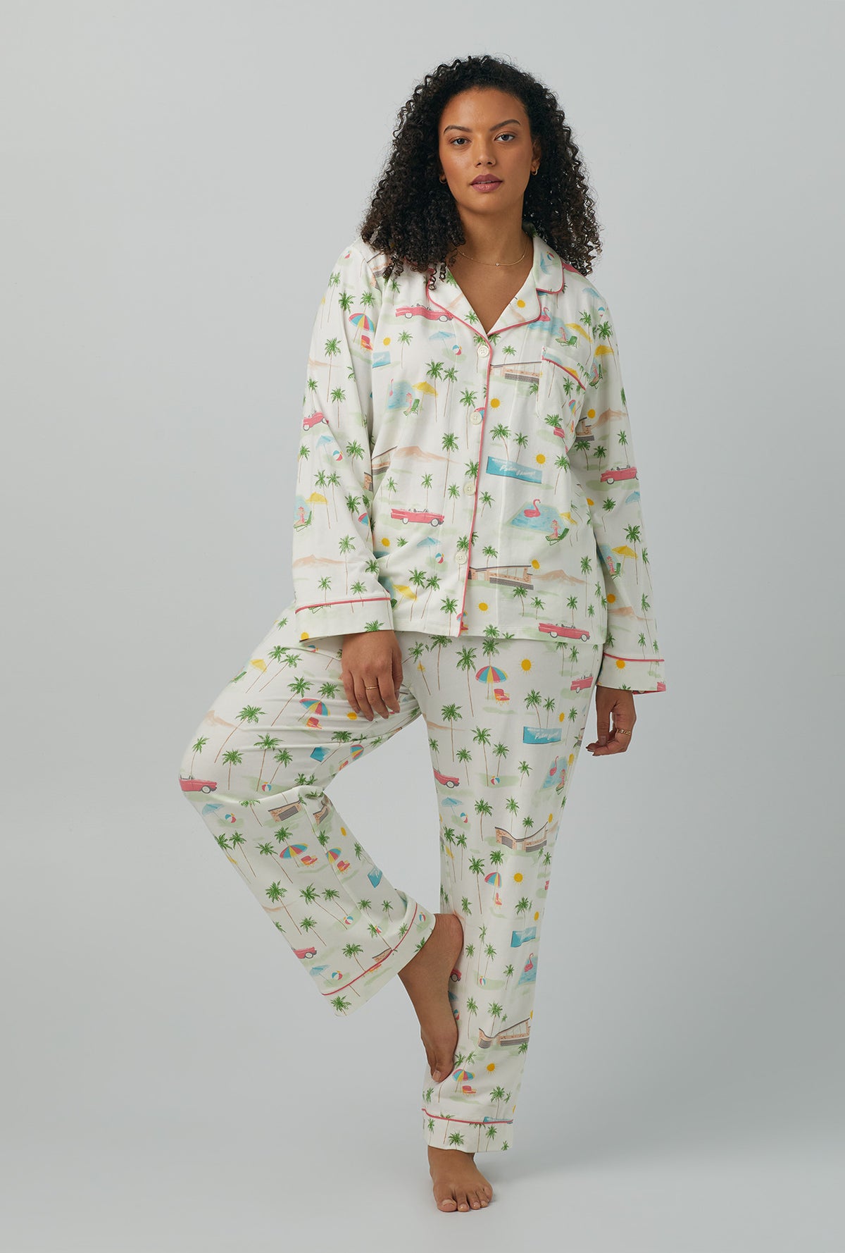 A lady wearing plus size white Long Sleeve Classic Stretch Jersey PJ Set with Welcome To Palm Springs print