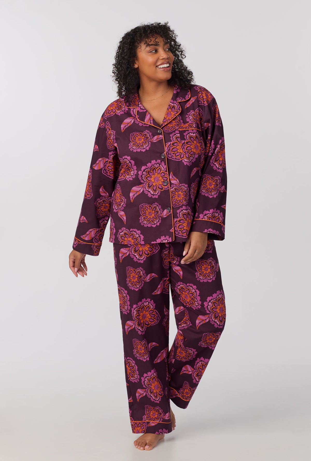 A lady wearing plus size long Sleeve Classic Woven Cotton Poplin PJ Set with African Floral print