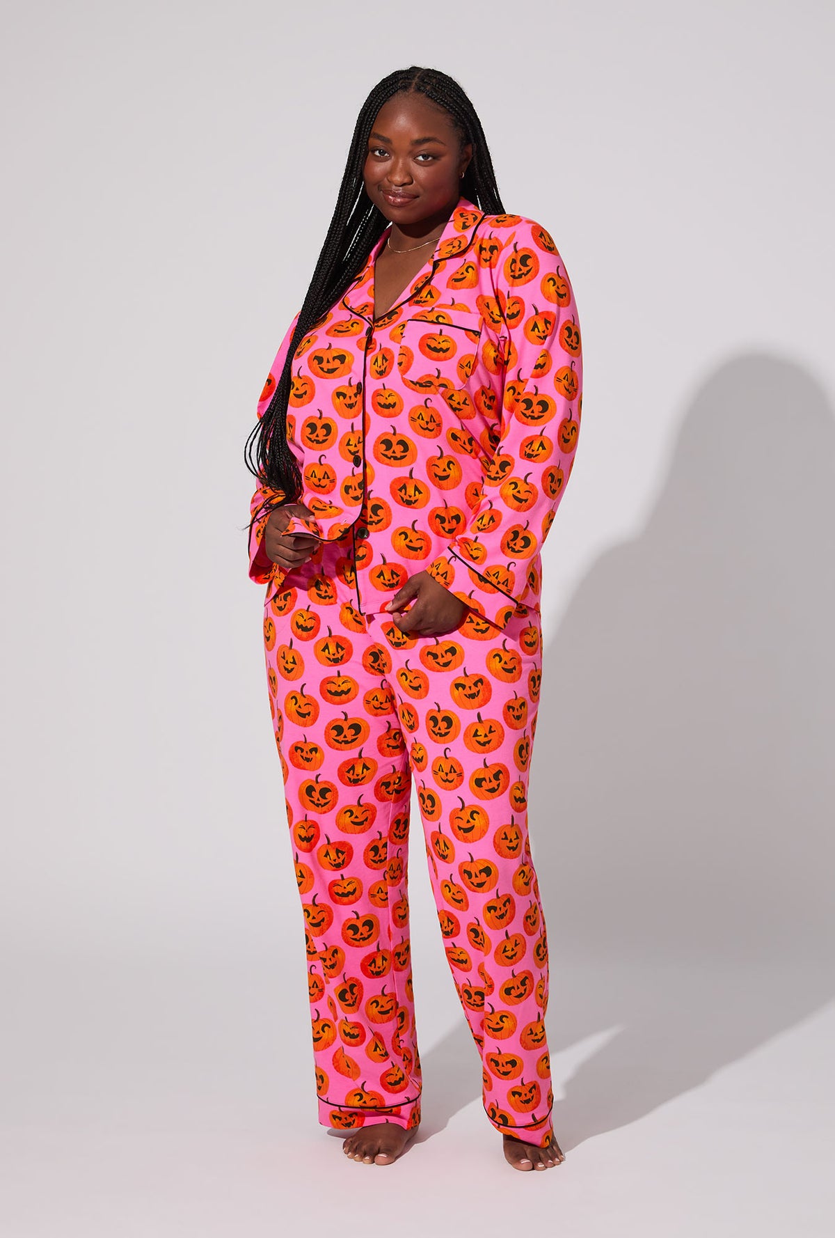 A lady wearing Jolly Jack-O-Lanterns Long Sleeve Classic Stretch Jersey PJ Set