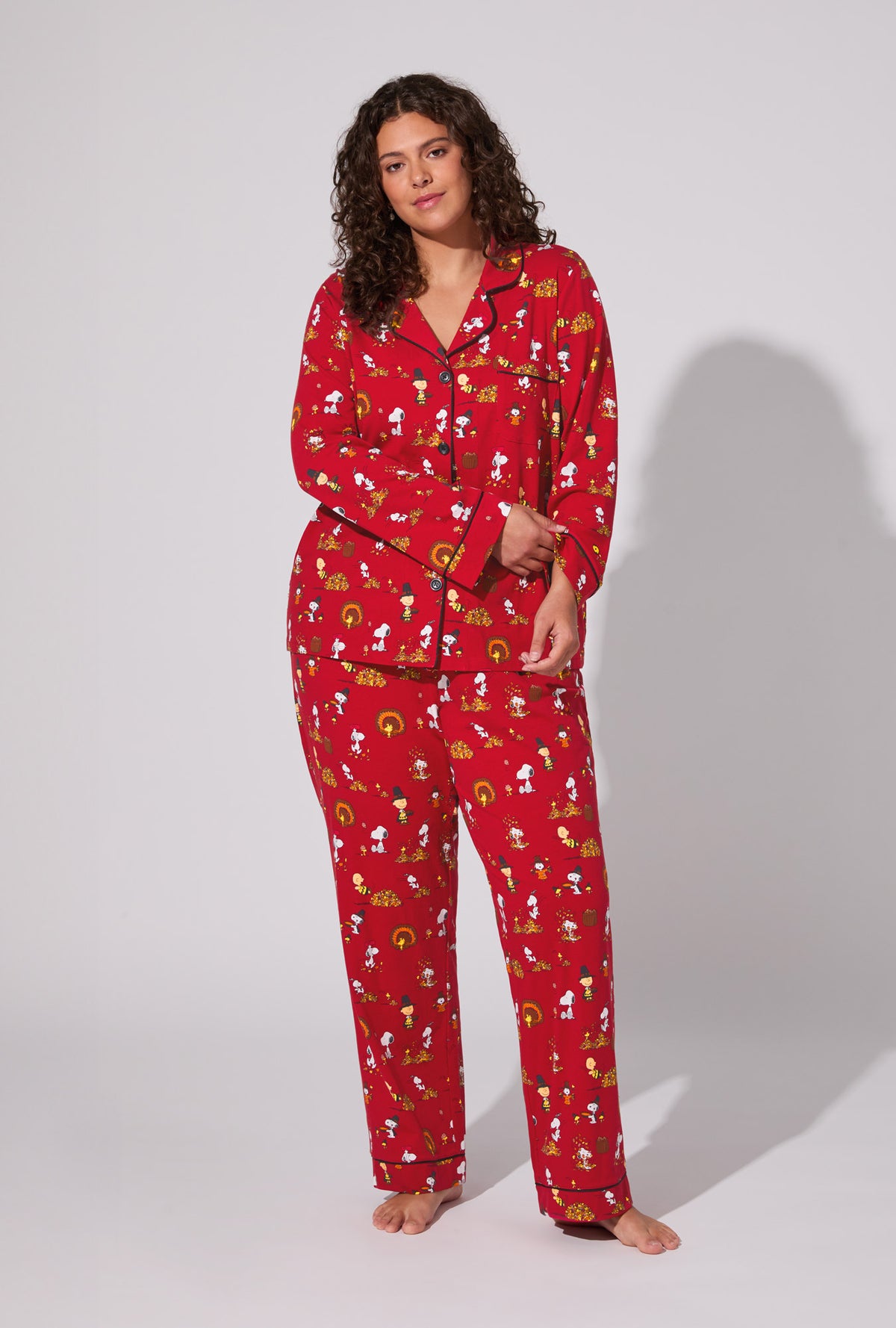 A lady wearing Peanuts® Snoopy&#39;s Thanksgiving Long Sleeve Classic Stretch Jersey PJ Set
