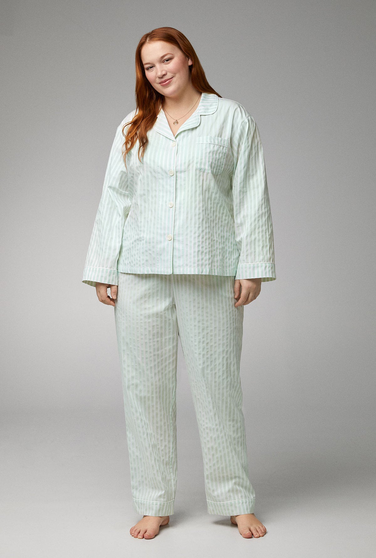 A lady wearing green Long Sleeve Classic Woven Cotton Sateen plus size PJ Set with Mint 3D Stripe print