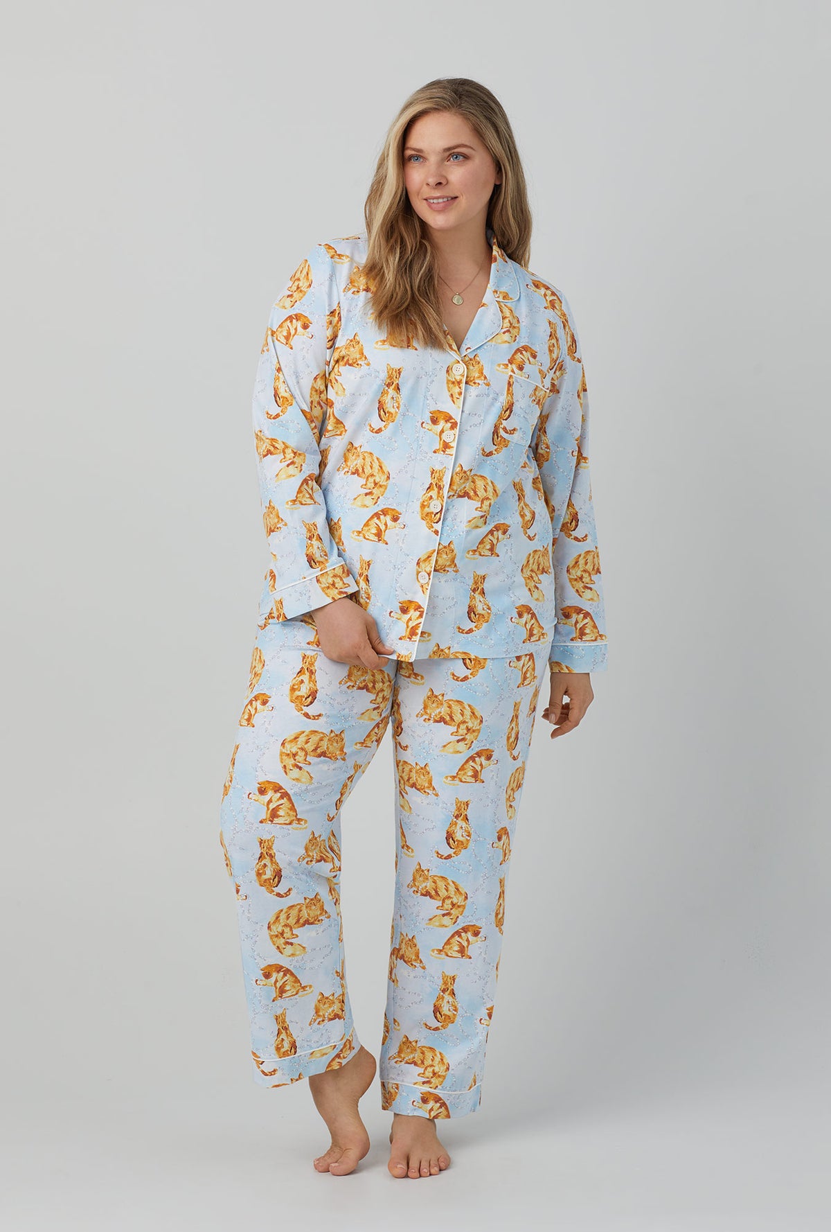 A lady wearing long sleeve classic stretch jersey pj set with fancy cats print