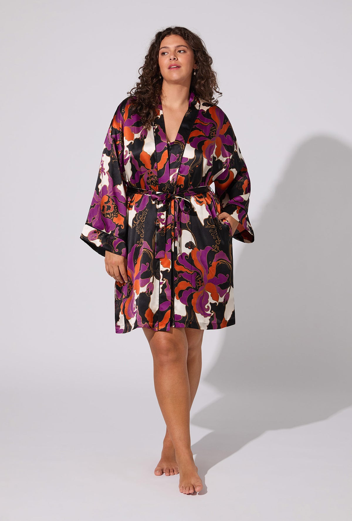 A lady wearing BedHead X Trina Turk Fall Floral Banded Collar Washable Silk Robe