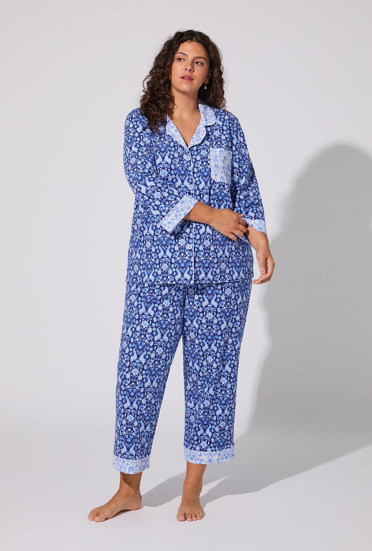 A lady wearing Bloomscape Blue 3/4 Sleeve Classic Stretch Jersey Cropped PJ Set