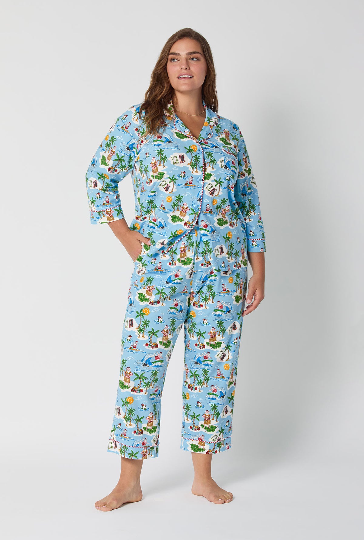 A lady wearing Surfin' Santa 3/4 Sleeve Classic Stretch Jersey Cropped Pj Set
