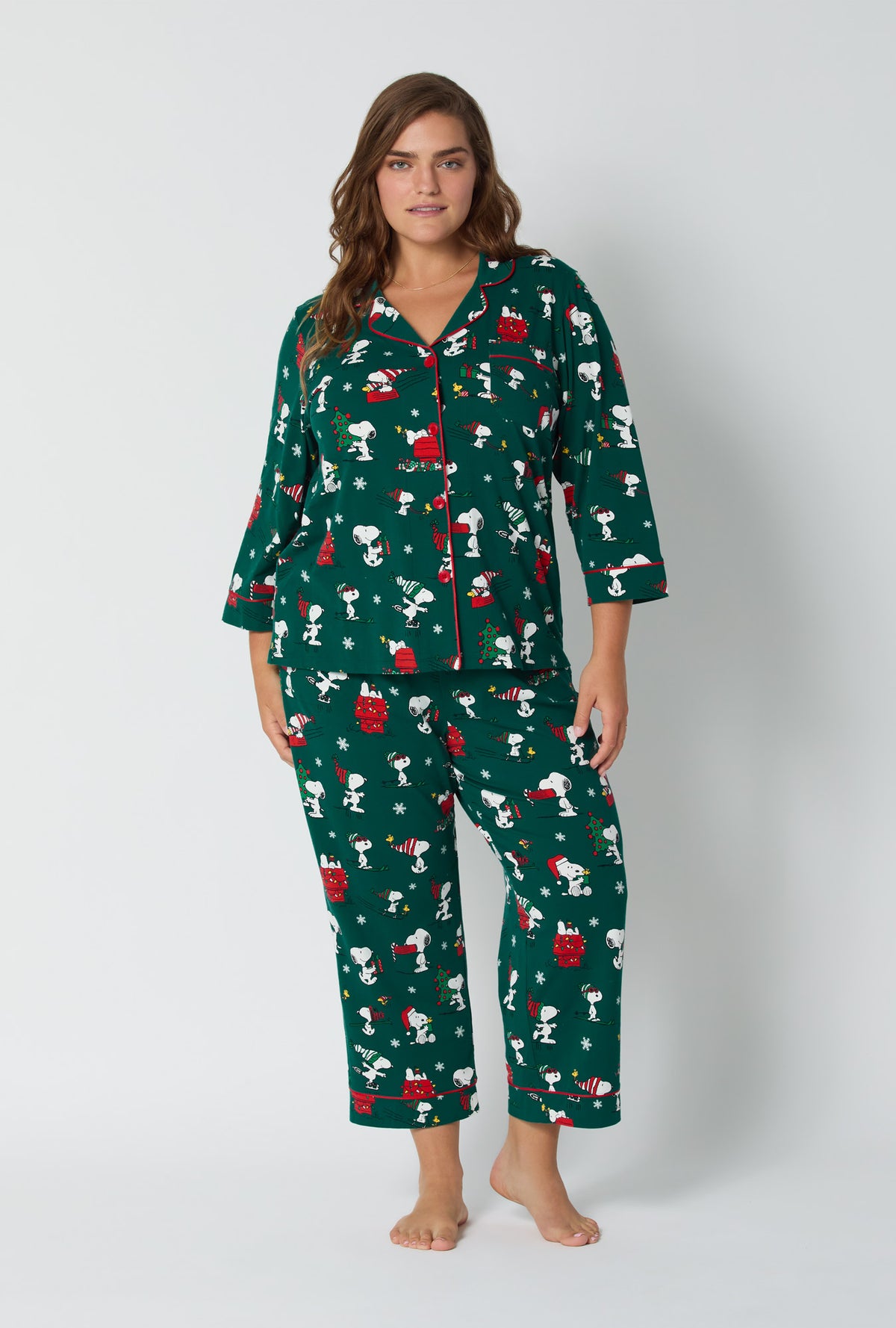 A lady wearing ®Snoopy's Holiday Fun 3/4 Sleeve Classic Stretch Jersey Cropped Pj Set