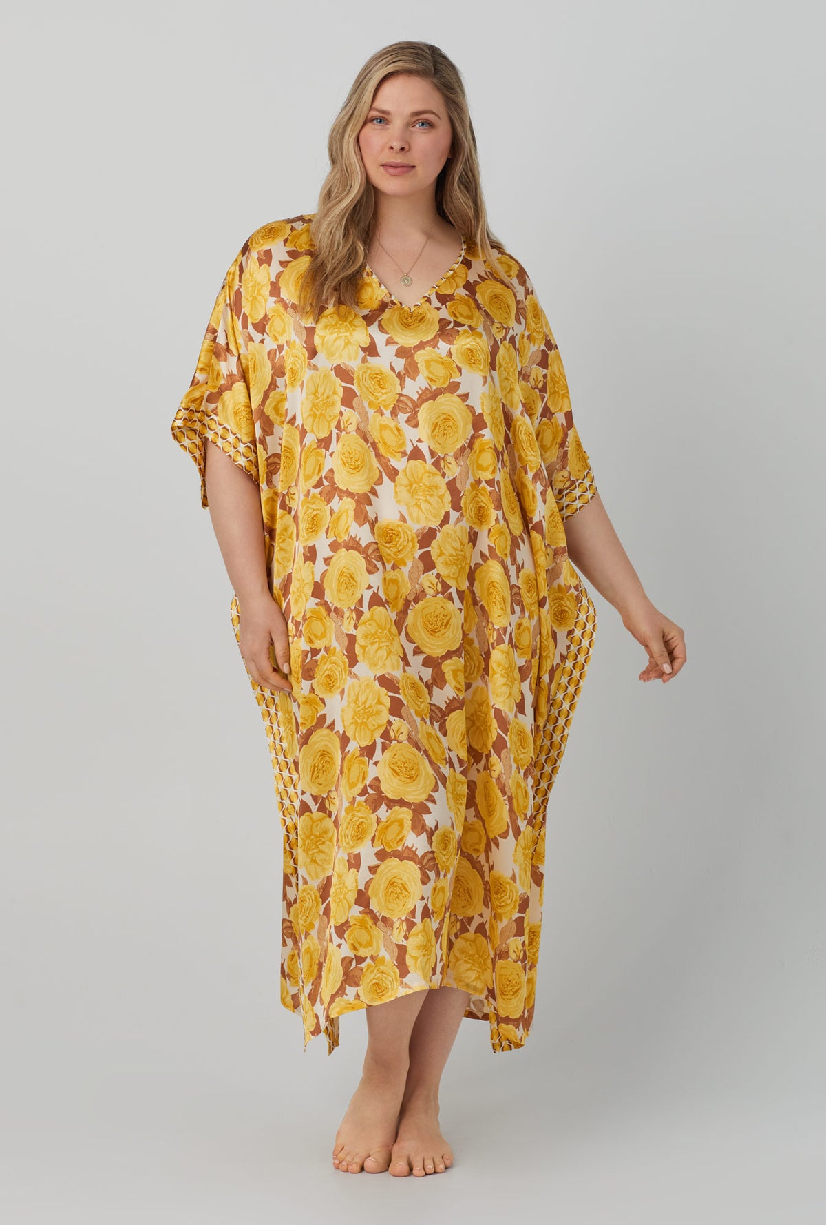 A lady wearing yellow Classic Washable Silk Caftan with Golden Roses print.