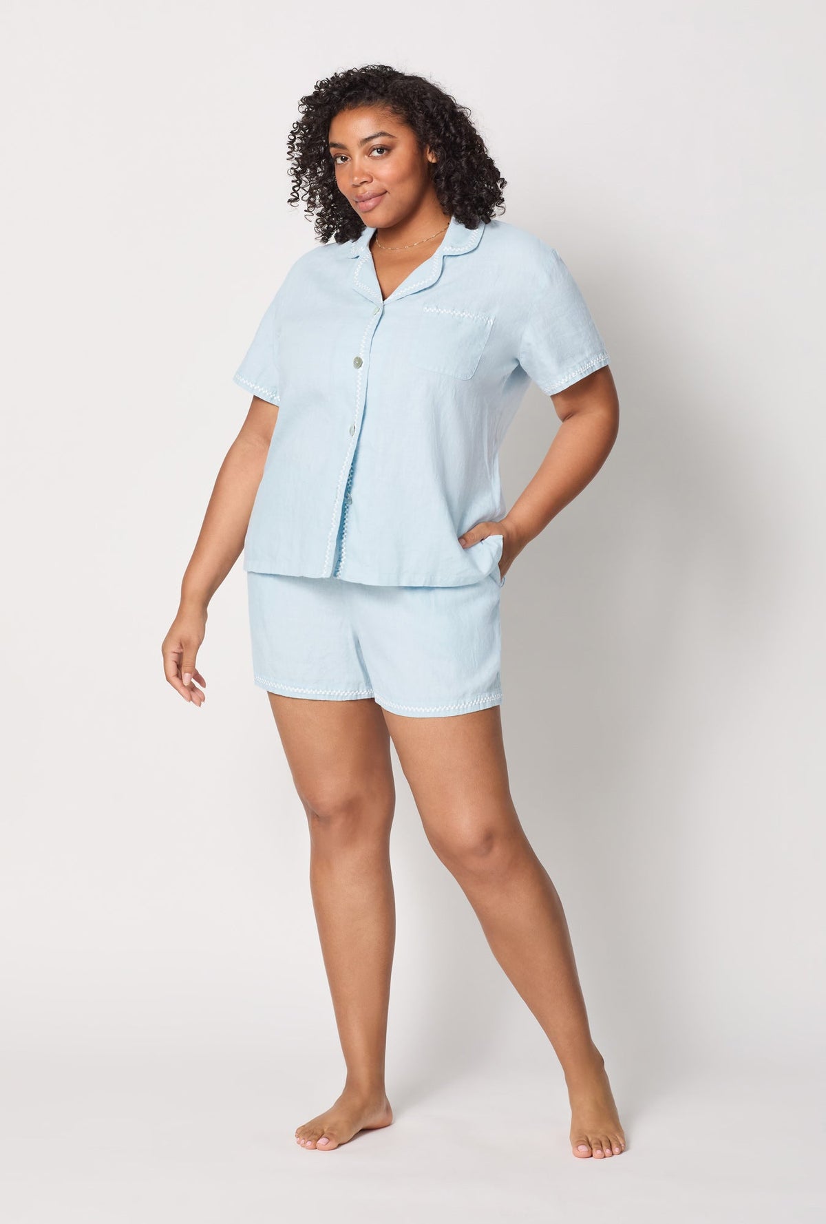 A lady wearing plus size Baby's Breath Blue Short Sleeve Classic Shorty Woven Linen Pj Set front view