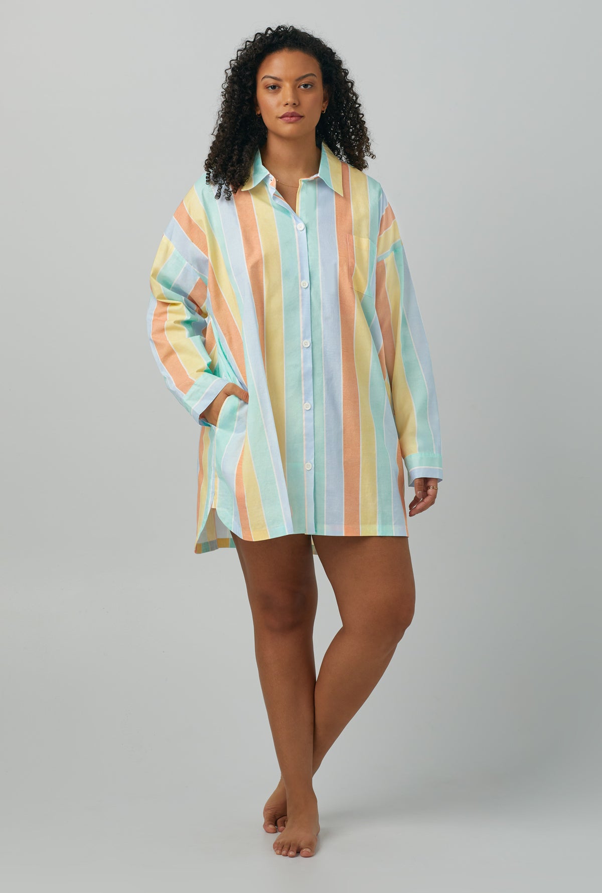 A lady wearing plus size multi color Woven Cotton Poplin Boyfriend Shirt with Sunset Stripe print