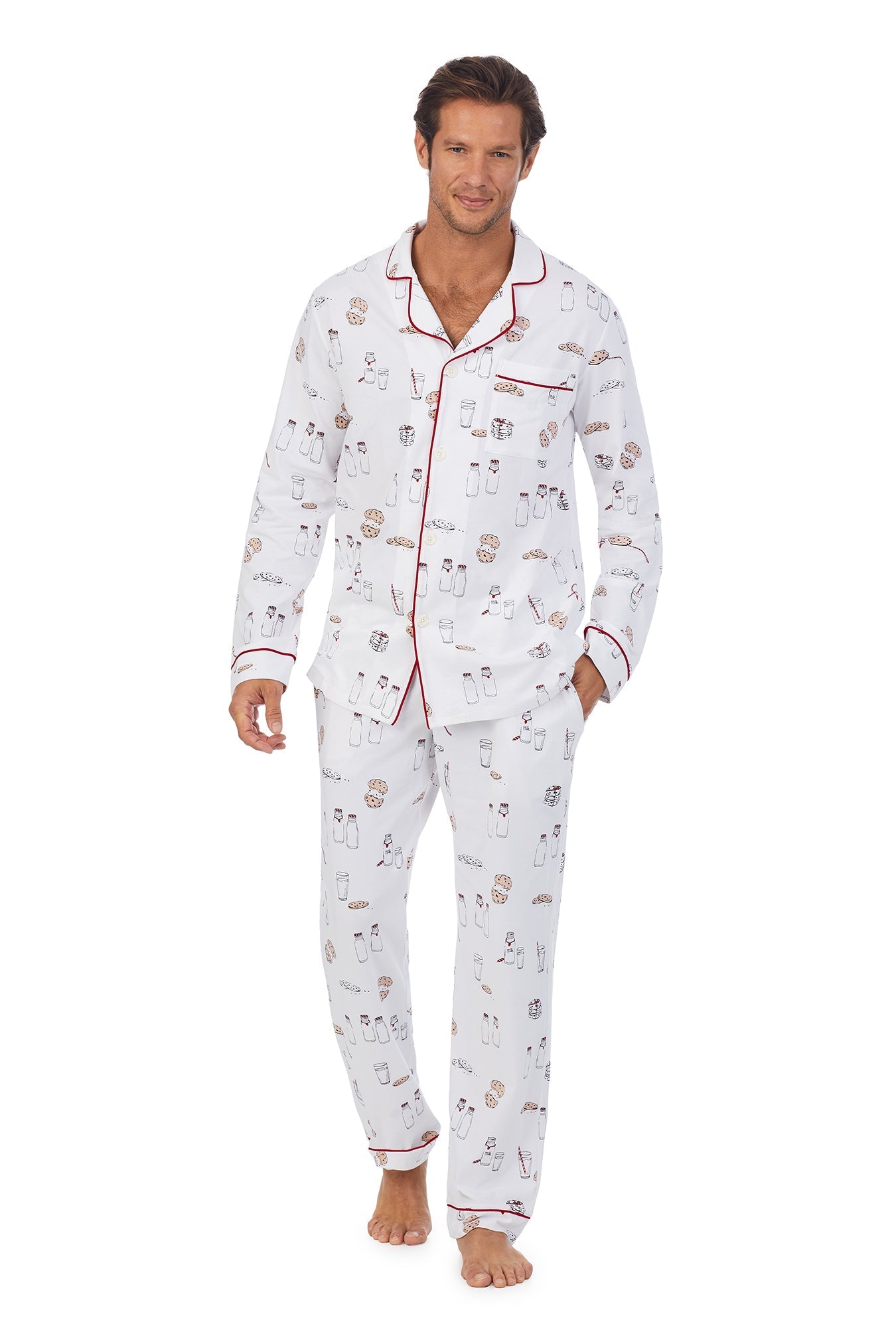 A man wearing a white long sleeve pj set with milk and cookies pattern. 
