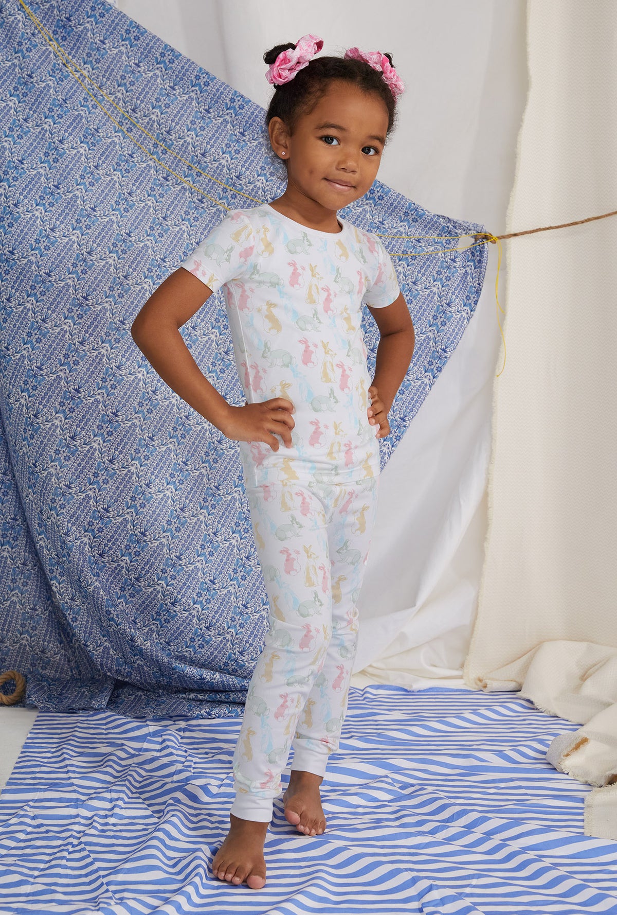 A girl wearing white short sleeve pj set with cottontail print