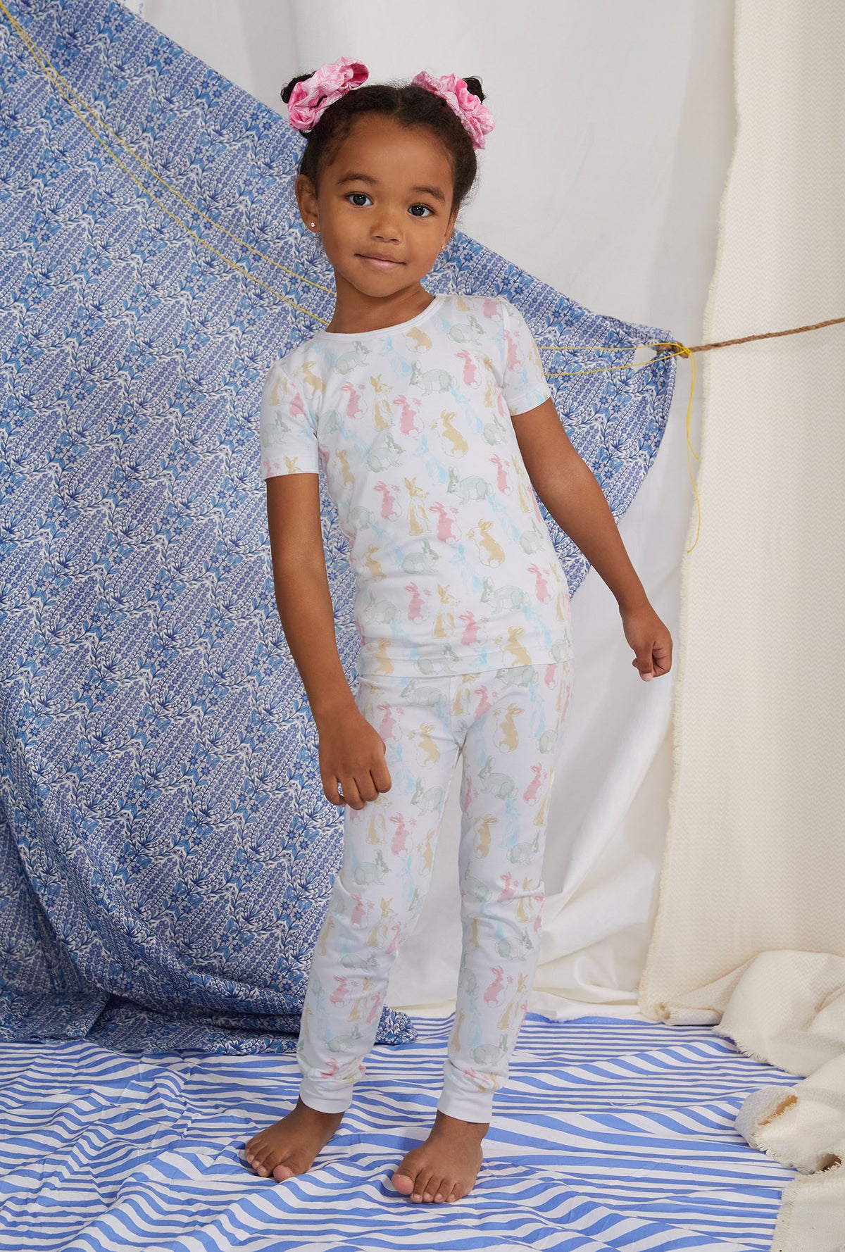 A girl wearing white short sleeve pj set with cottontail print