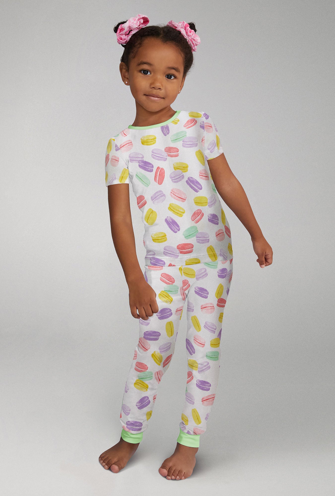 A girl wearing Short Sleeve Stretch Jersey Kids PJ Set with Delice De Macarons  print