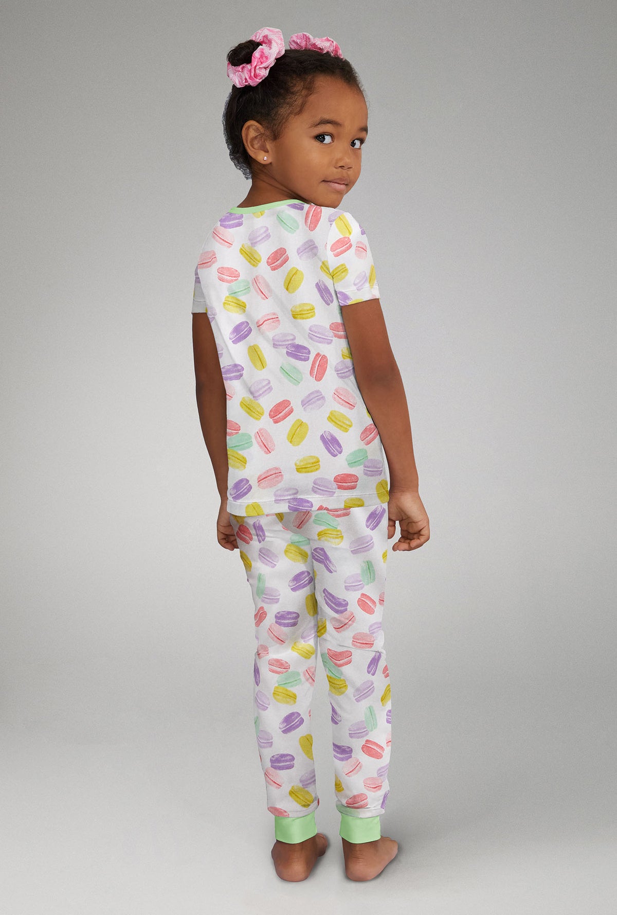 A girl wearing Short Sleeve Stretch Jersey Kids PJ Set with Delice De Macarons  print