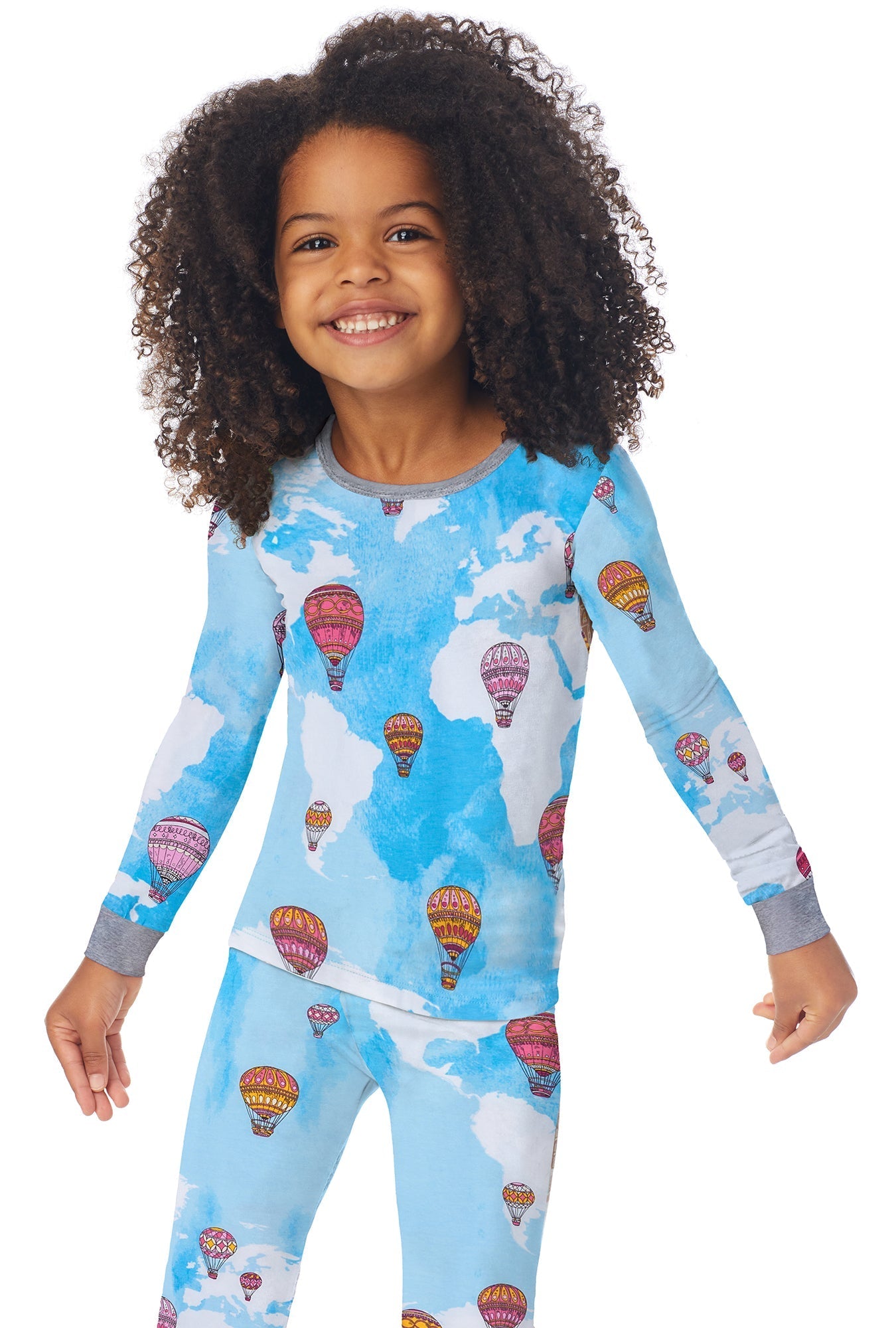 A kid wearing a long sleeve pj set with parachute in the sky pattern.