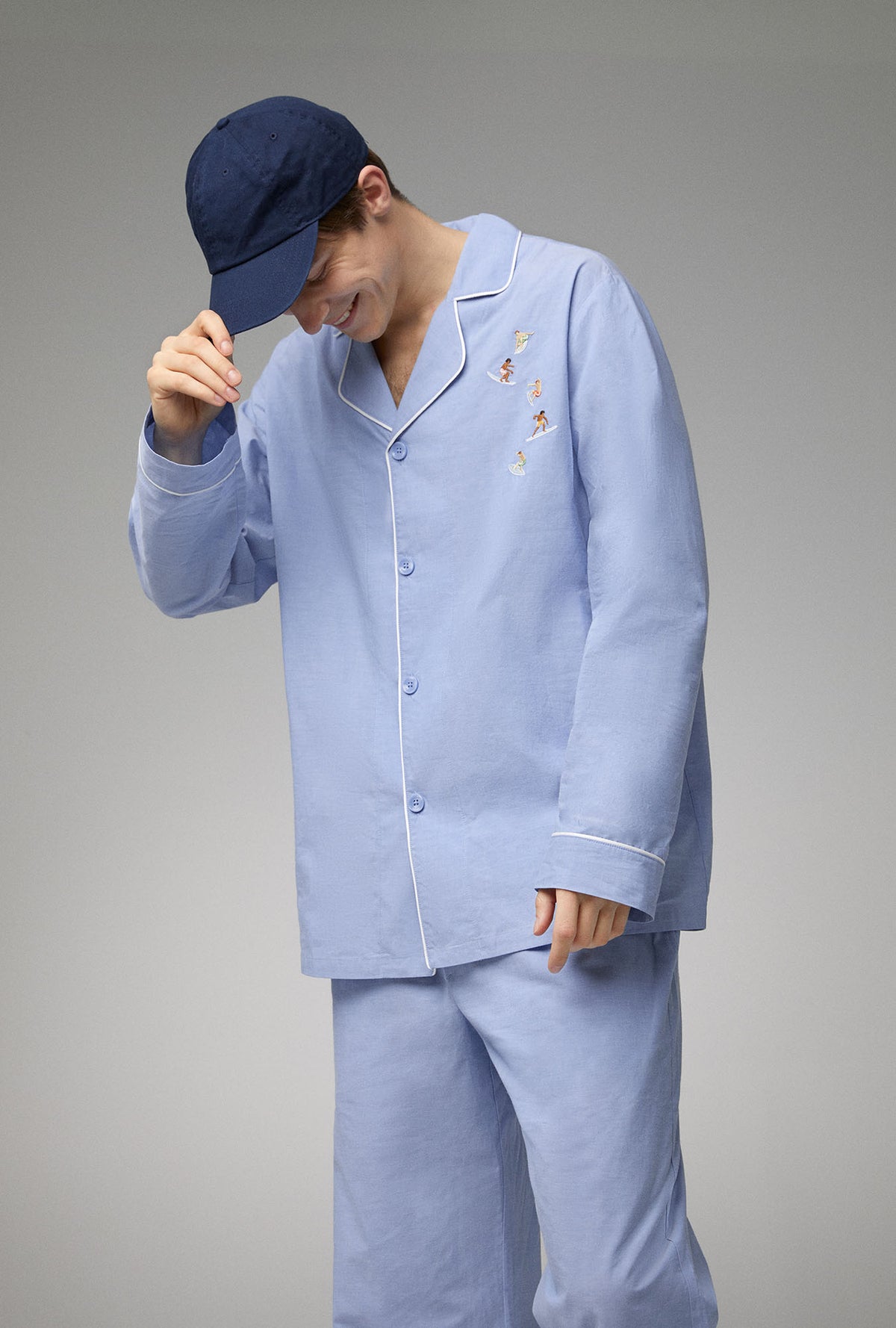 A man wearing blue long sleeve classic woven cotton poplin pj set with chambray print.