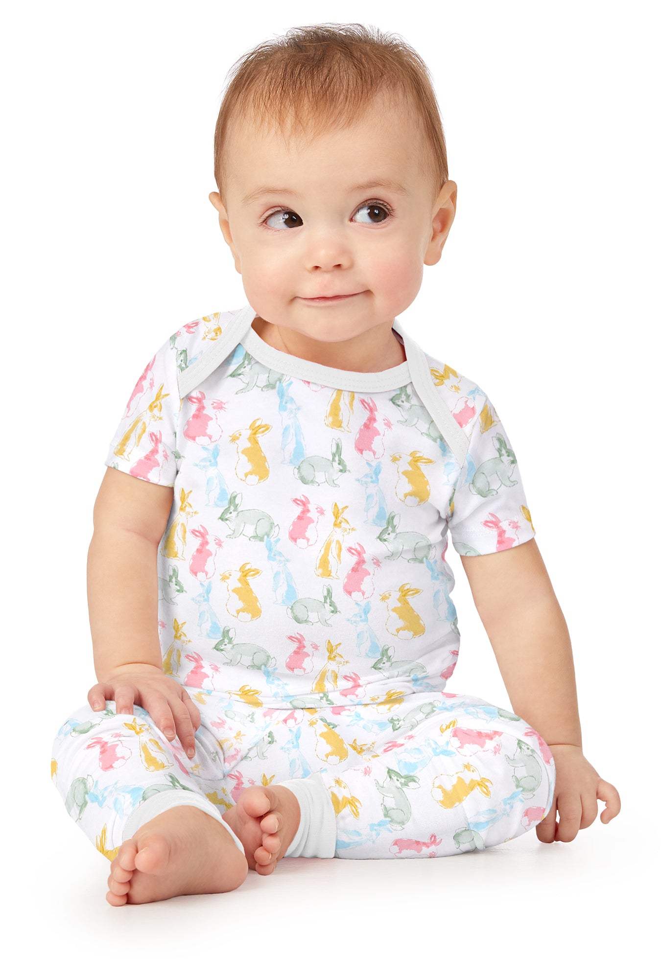 A toddler wearing white short sleeve pj set with cottontail print